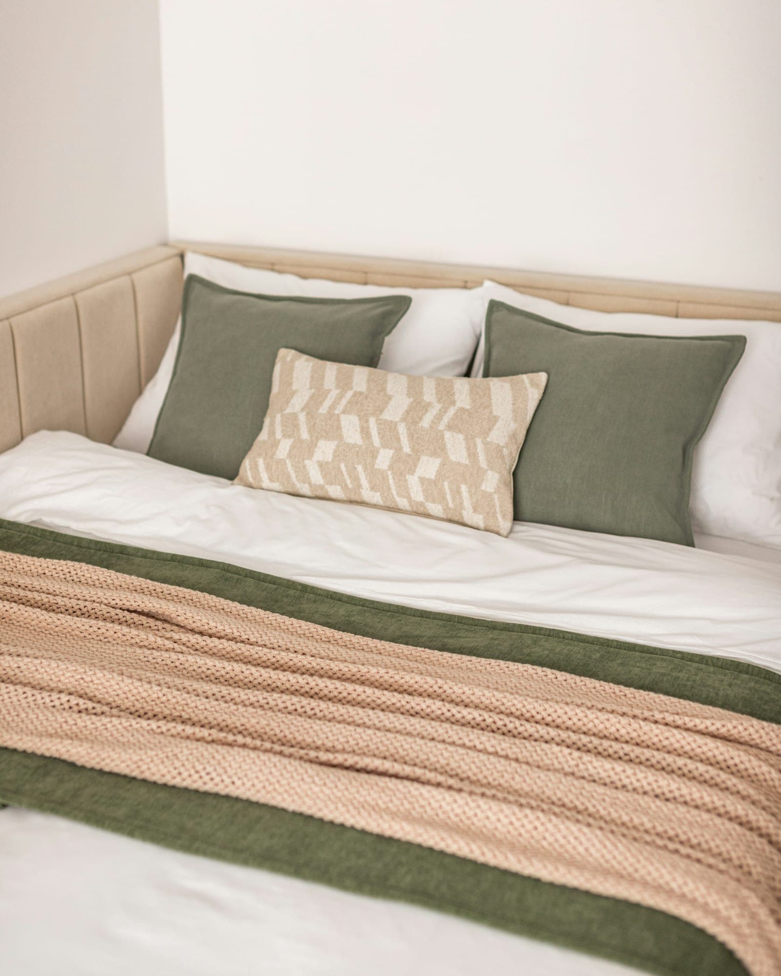 Neatly made bed in a short-stay apartment