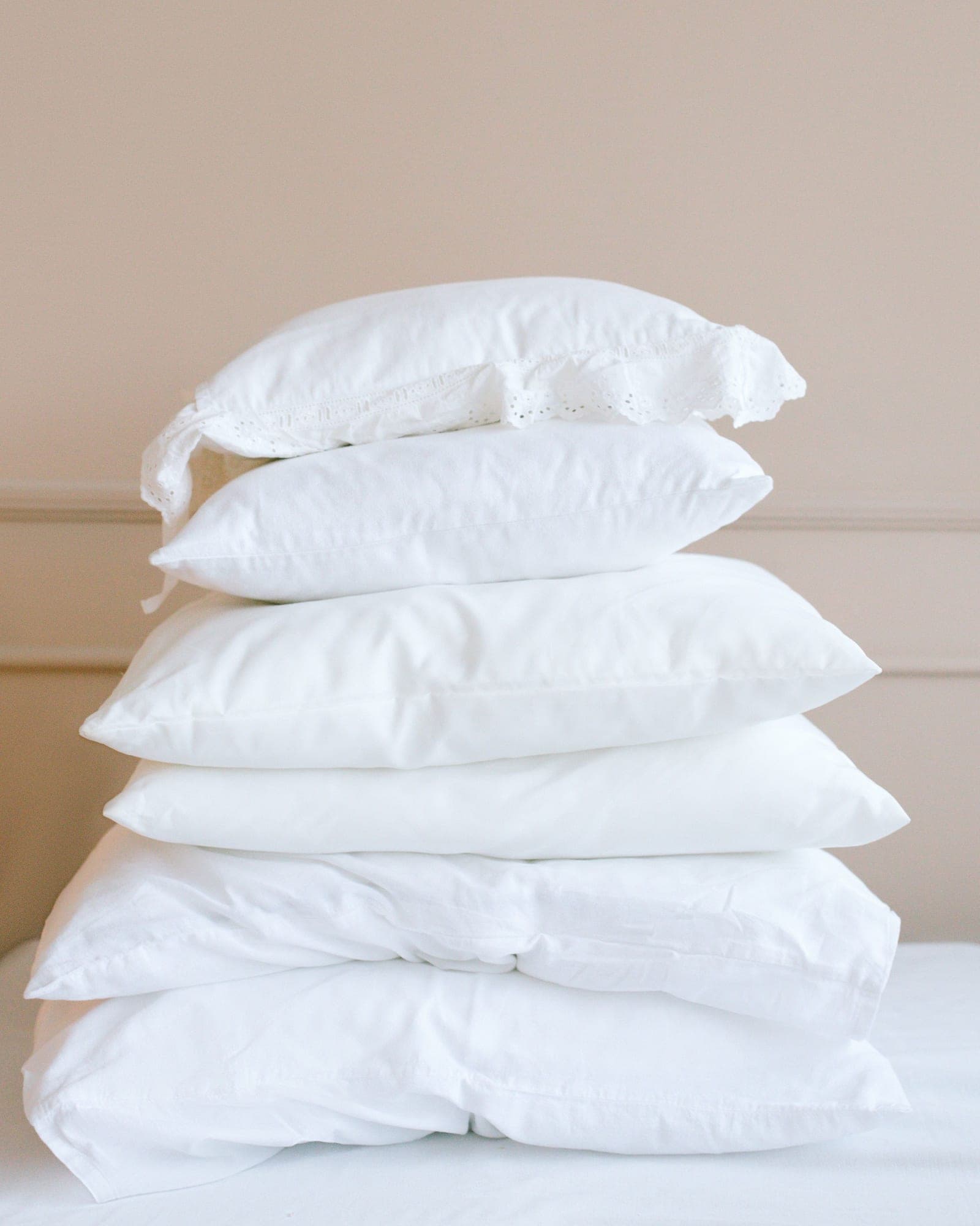 A tall stack of plump white pillows