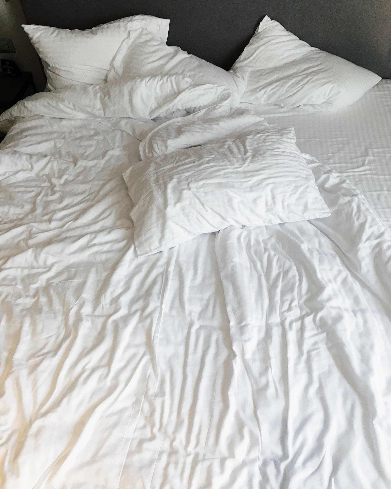 Lofted white duvet on a bed with white pillows