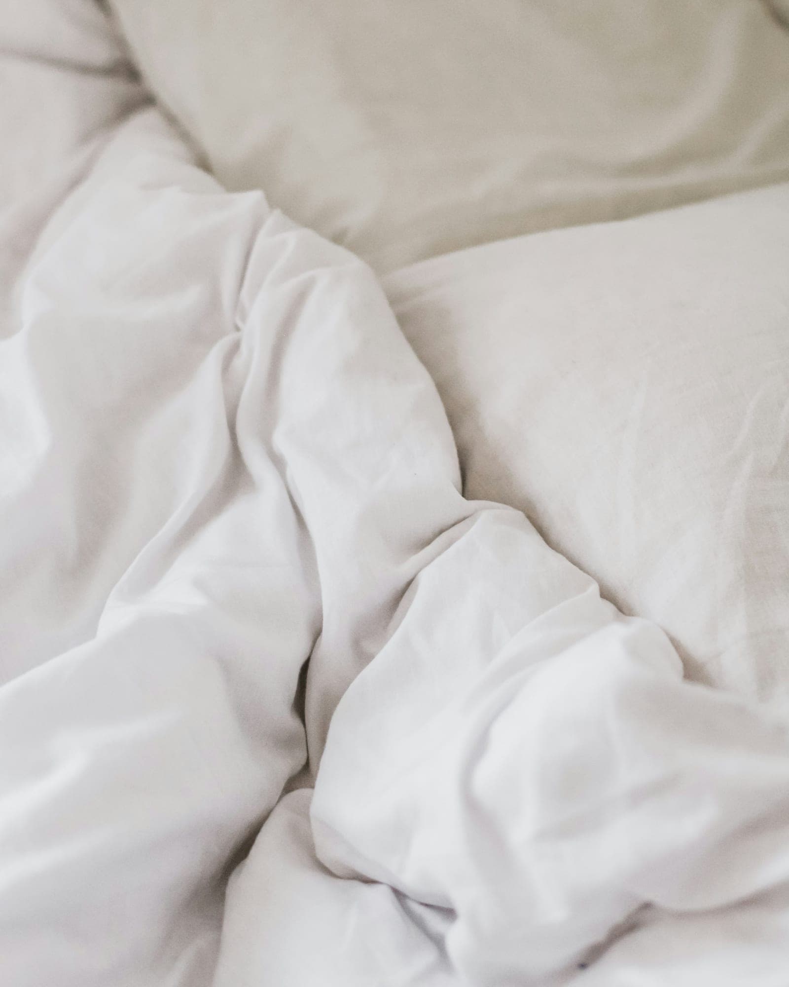 Soft folds of ivory cotton bedding
