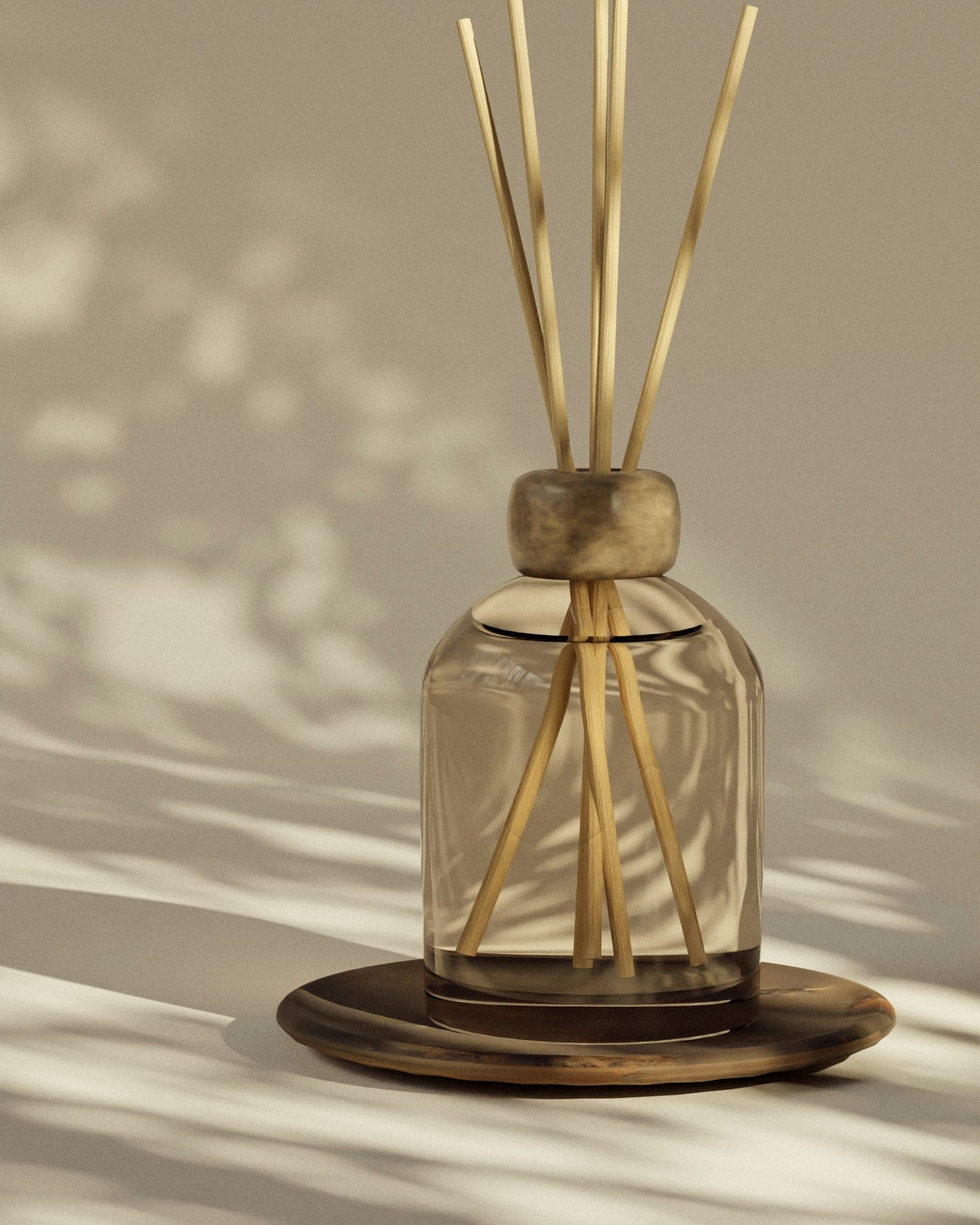 Glass reed diffuser with natural rattan reeds on a wooden dish